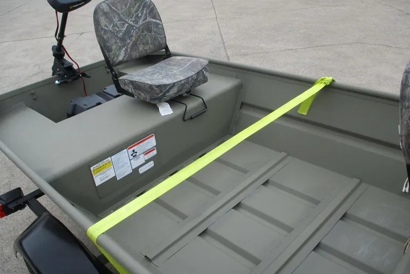 Slide: The Image of 2025 Tracker Grizzly 1436 Utility boat interior with camo seats and safety labels. - 4