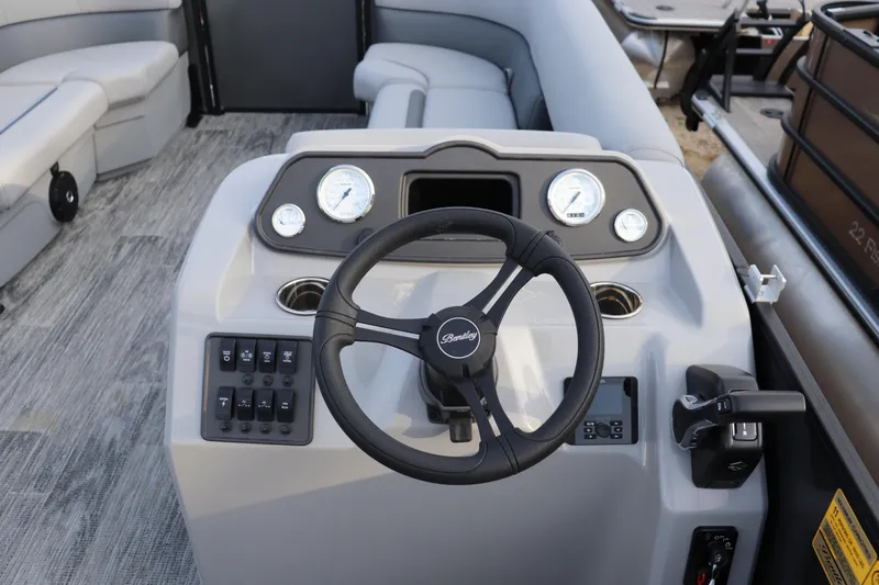 Slide: The Image of 2026 Bentley Pontoons LE 200 Cruise dashboard with steering wheel and controls. - 5