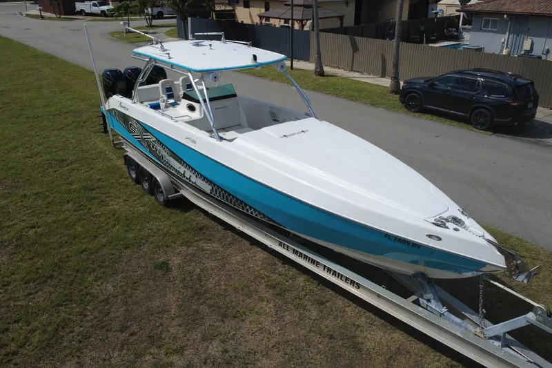 Slide: The Image of 2016 Extreme Boats XC 38 Express on trailer, parked on grass. - 10