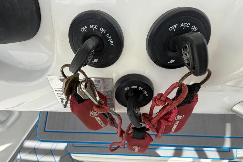 Slide: The Image of Keys in ignition of 2016 Extreme Boats XC 38 Express, featuring dual start switches. - 105