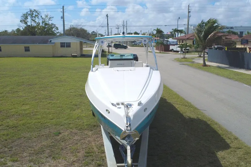 Slide: The Image of 2016 Extreme Boats XC 38 Express on trailer, parked on grass, under a partly cloudy sky. - 12