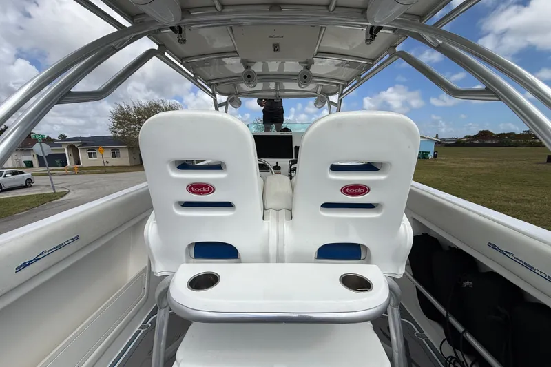 Slide: The Image of 2016 Extreme Boats XC 38 Express interior with seating and cooler under a blue sky. - 121