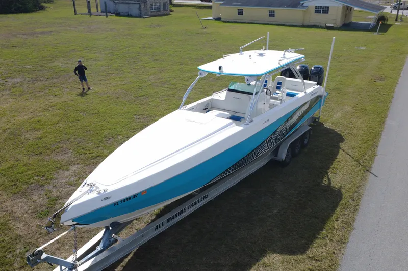 Slide: The Image of 2016 Extreme Boats XC 38 Express on trailer, parked on grass near road. - 13