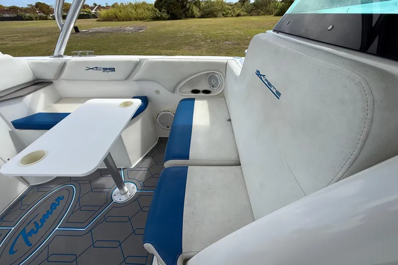 Slide: The Image of 2016 Extreme Boats XC 38 Express interior with blue and white seating, table, and speakers. - 137