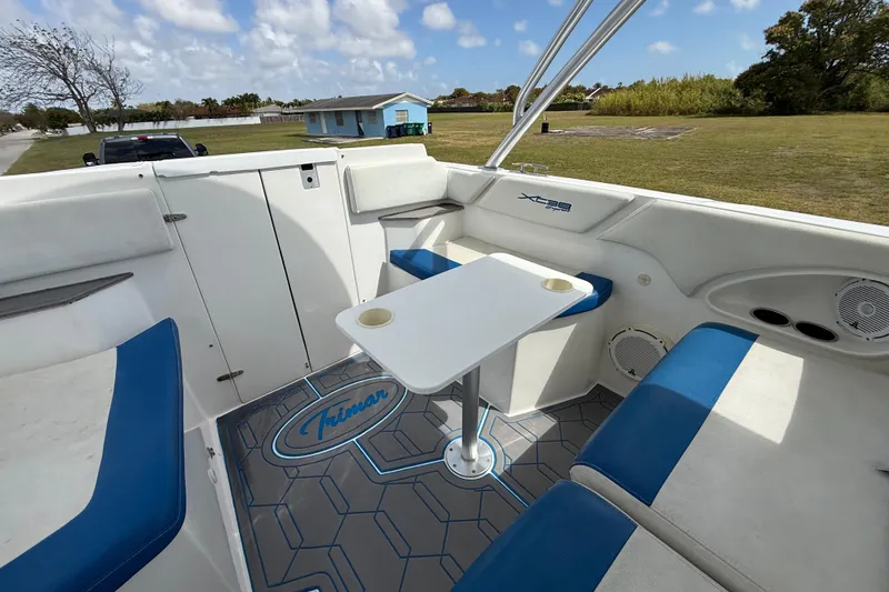 Slide: The Image of 2016 Extreme Boats XC 38 Express interior with seating and table, featuring "Trimar" flooring. - 138