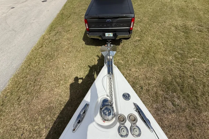 Slide: The Image of 2016 Extreme Boats XC 38 Express bow with anchor, parked near a black truck on grass. - 145