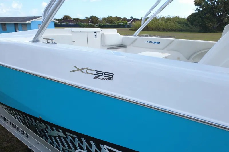 Slide: The Image of 2016 Extreme Boats XC 38 Express, blue and white exterior, parked outdoors. - 15