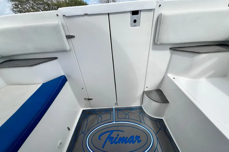 Slide: The Image of 2016 Extreme Boats XC 38 Express interior with white seating and blue logo. - 180