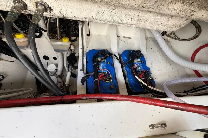Slide: The Image of Battery compartment of 2016 Extreme Boats XC 38 Express, featuring dual blue batteries. - 199