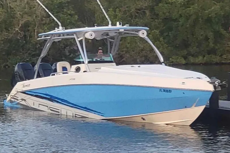 Slide: The Image of 2016 Extreme Boats XC 38 Express on trailer, parked on grass. - 2