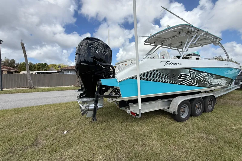 Slide: The Image of 2016 Extreme Boats XC 38 Express on trailer, featuring powerful Mercury 400 engine. - 45