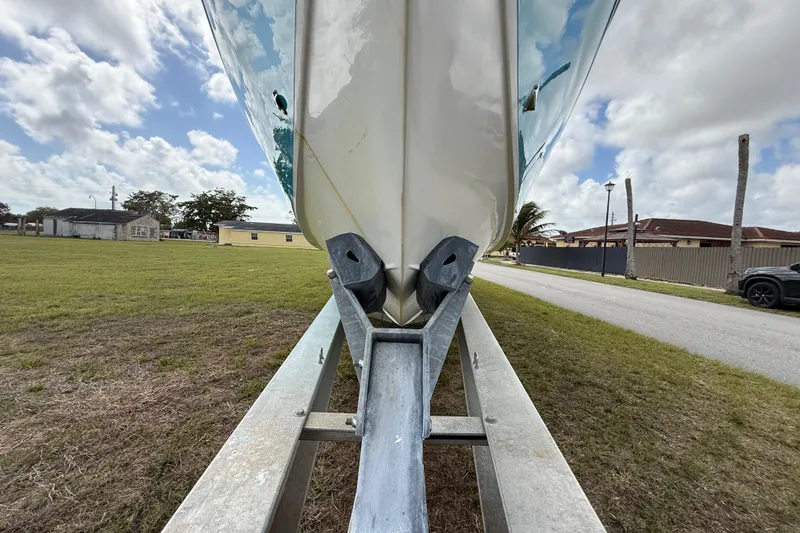 Slide: The Image of 2016 Extreme Boats XC 38 Express on trailer, grassy area, cloudy sky. - 64