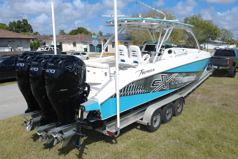 Slide: The Image of 2016 Extreme Boats XC 38 Express with triple Mercury 400 engines on trailer. - 7