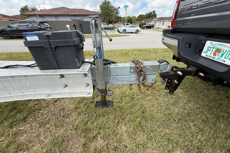 Slide: The Image of Trailer hitch connection for 2016 Extreme Boats XC 38 Express on grassy area. - 95