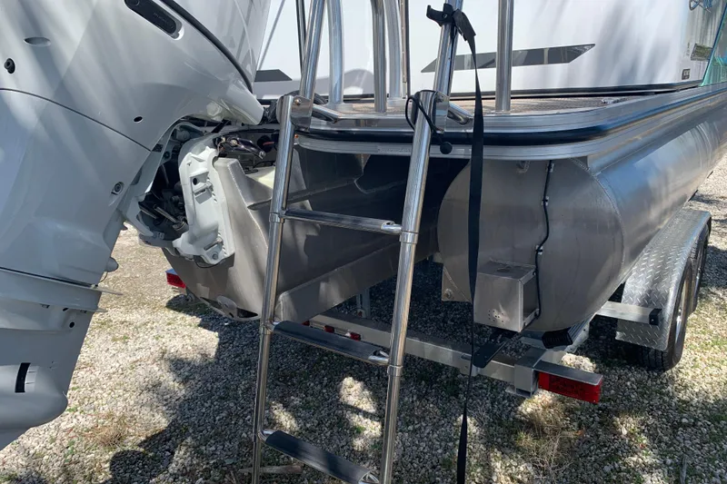 Slide: The Image of 2024 Silver Wave 2210CLS boat with ladder and outboard motor on trailer. - 21