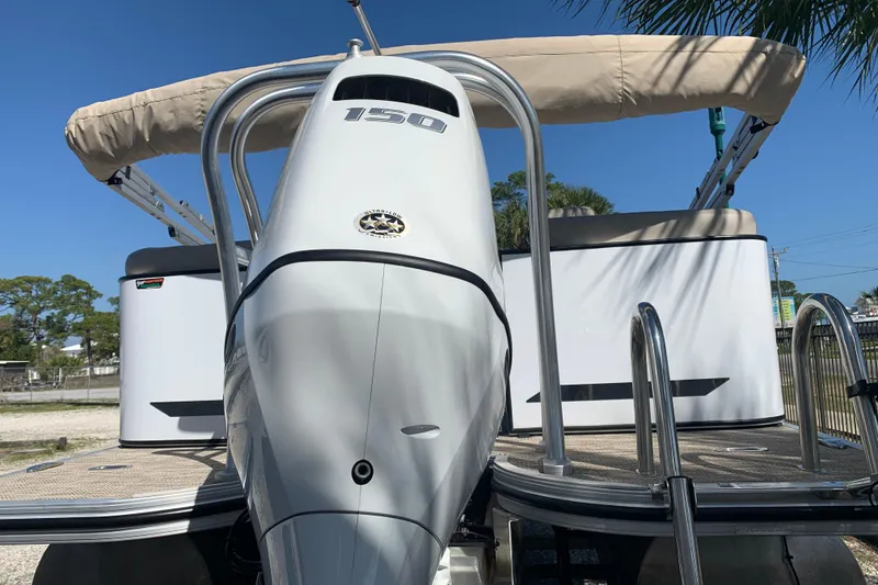 Slide: The Image of 2024 Silver Wave 2210CLS boat with 150 horsepower engine, beige canopy, and sleek design. - 22