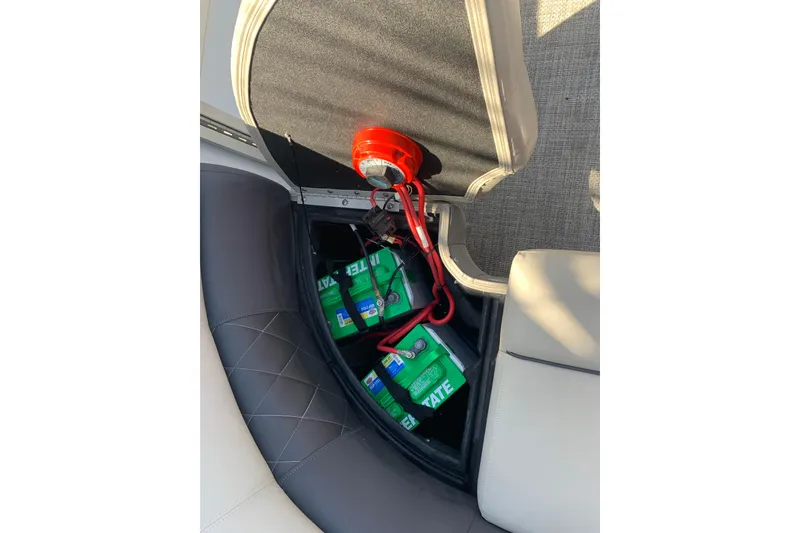 Slide: The Image of 2024 Silver Wave 2210CLS boat battery compartment with wiring and seating. - 25