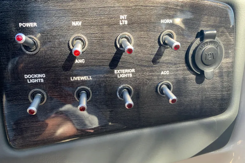 Slide: The Image of Control panel of 2024 Silver Wave 2210CLS boat with switches and 12V outlet. - 26