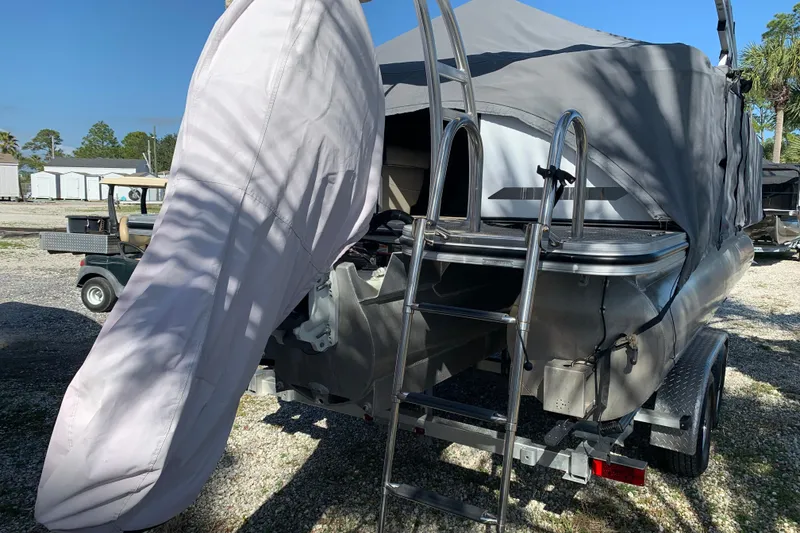 Slide: The Image of 2024 Silver Wave 2210CLS boat with cover, ladder, and trailer in outdoor setting. - 38