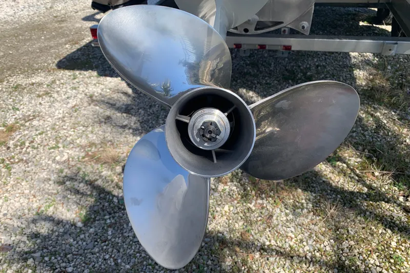 Slide: The Image of Close-up of a 2024 Silver Wave 2210CLS boat propeller on gravel surface. - 39