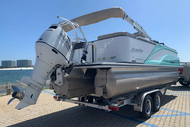 Slide: The Image of 2024 Silver Wave 2210CLS pontoon boat with Suzuki outboard motor on a trailer by the water. - 4