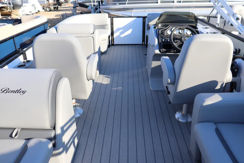 Slide: The Image of 2026 Bentley Pontoons Legacy 203 Navigator interior with gray seating and steering console. - 9