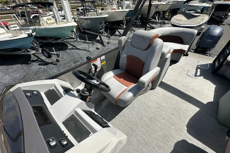 Slide: The Image of 2022 Bennington 22 L Quad Bench interior with steering console and seating. - 11