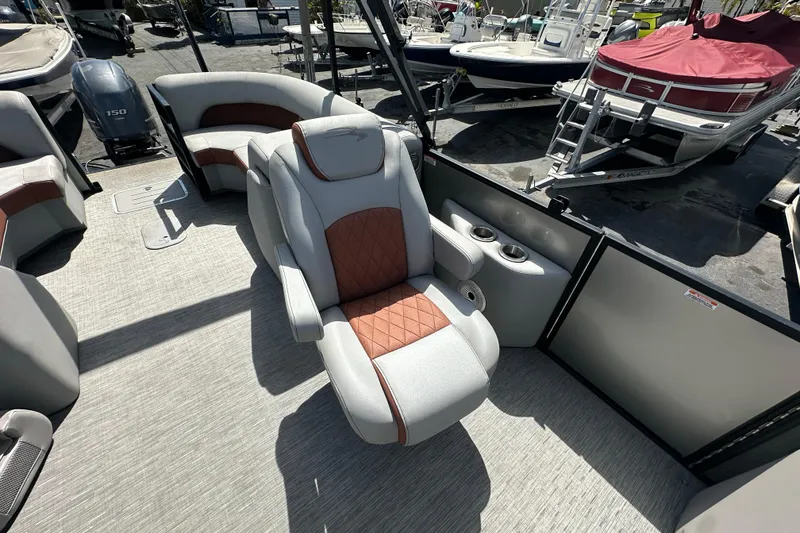 Slide: The Image of 2022 Bennington 22 L Quad Bench boat interior with luxurious seating and cup holders. - 12