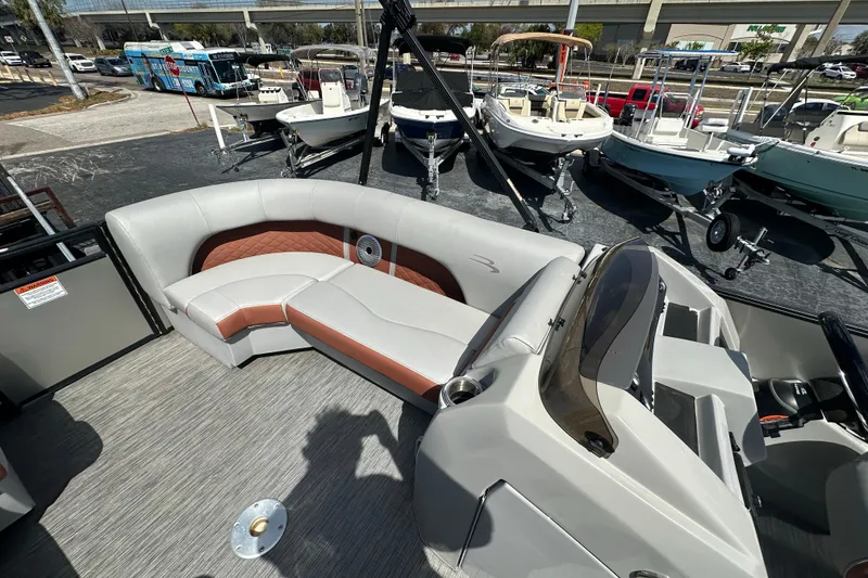 Slide: The Image of 2022 Bennington 22 L Quad Bench pontoon boat interior with stylish seating and helm. - 14