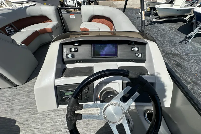 Slide: The Image of 2022 Bennington 22 L Quad Bench boat interior with steering wheel and control panel. - 17