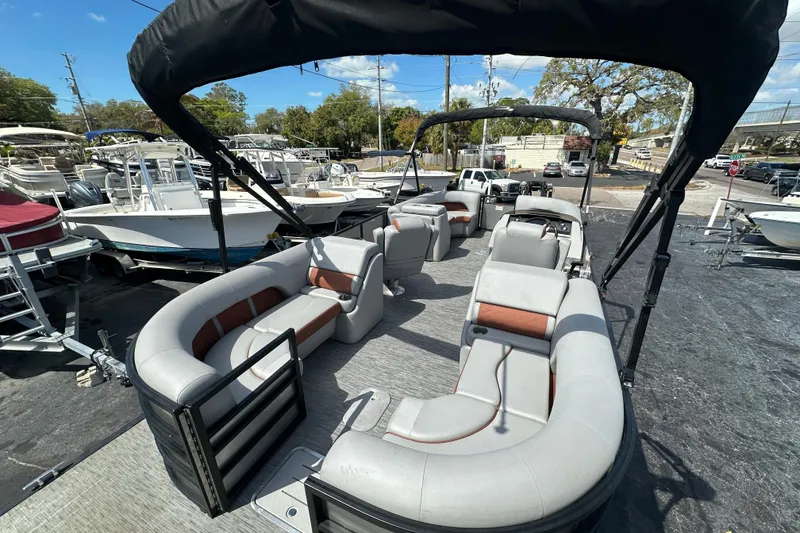 Slide: The Image of 2022 Bennington 22 L Quad Bench pontoon boat with spacious seating and canopy. - 8