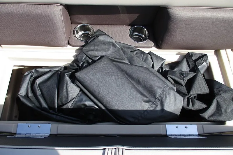 Slide: The Image of Storage compartment in 2026 Bentley Pontoons Legacy 240 Cruise with cup holders and cover. - 13