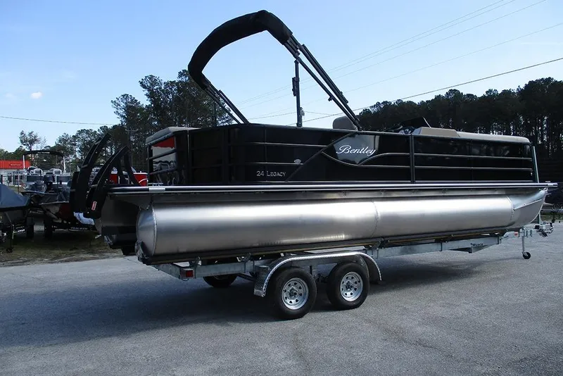 Slide: The Image of 2026 Bentley Pontoons Legacy 240 Cruise on trailer, sleek black design, parked outdoors. - 6