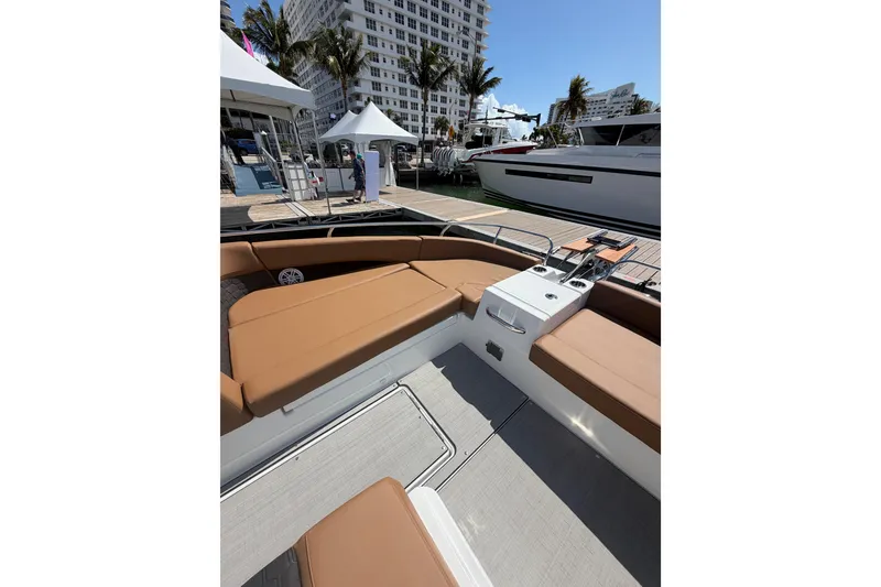 Slide: The Image of 2026 Jeanneau TH33 boat interior with tan seating, docked at marina. - 10