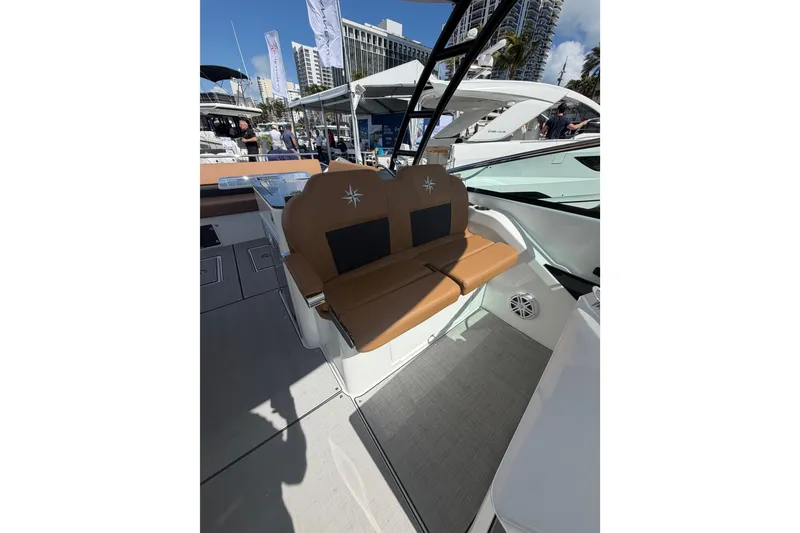 Slide: The Image of 2026 Jeanneau TH33 boat interior with tan seating and modern design. - 13