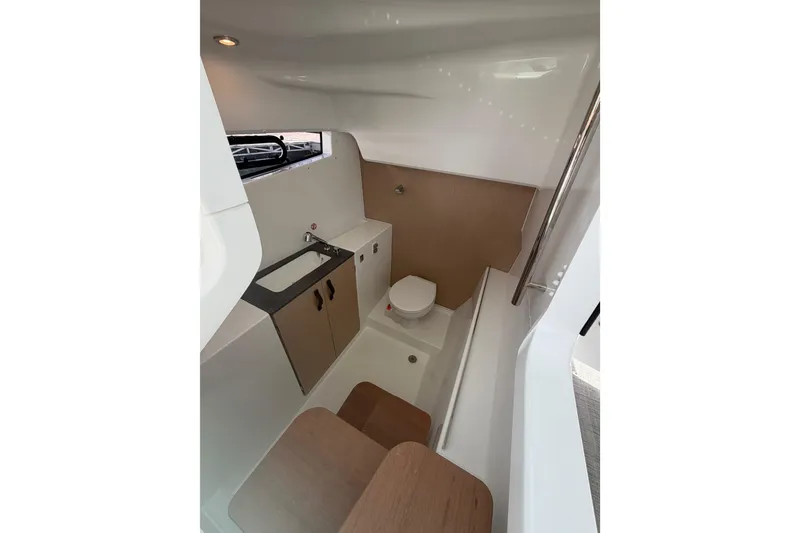 Slide: The Image of Modern bathroom interior of 2026 Jeanneau TH33 boat, featuring sink, toilet, and storage. - 15