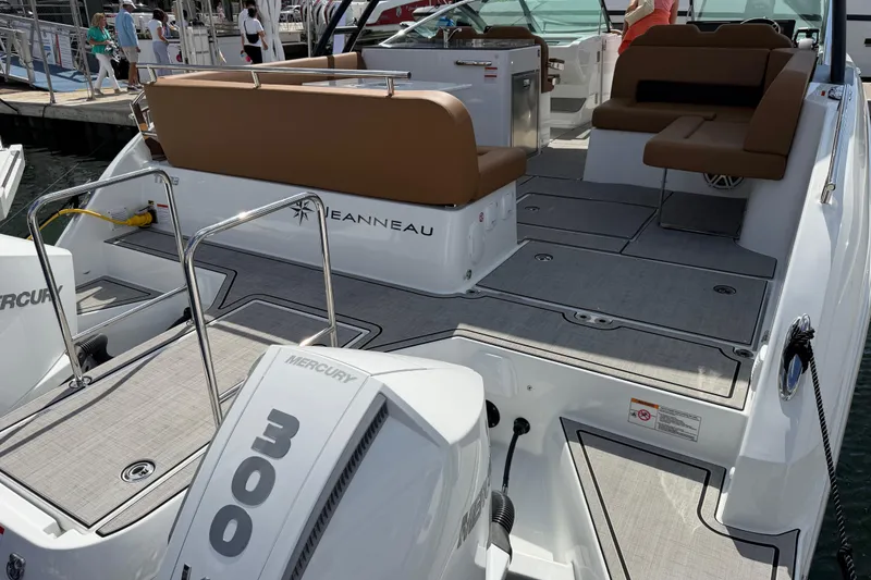 Slide: The Image of 2026 Jeanneau TH33 boat with Mercury 300 engine, featuring spacious seating and modern design. - 2