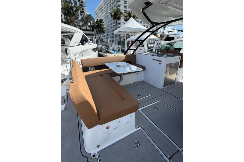 Slide: The Image of 2026 Jeanneau TH33 boat interior with brown seating and modern amenities. - 4