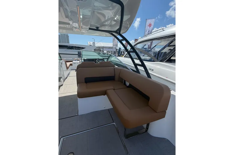 Slide: The Image of 2026 Jeanneau TH33 boat interior with brown seating and modern design. - 5