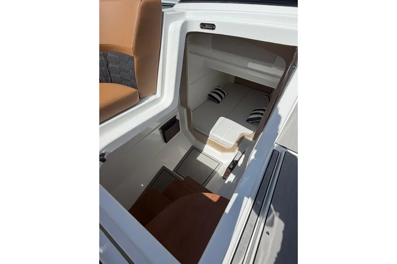 Slide: The Image of Interior view of 2026 Jeanneau TH33 boat cabin with seating and cushions. - 9