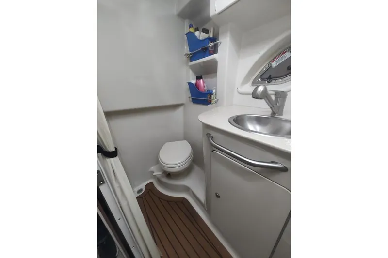 Slide: The Image of 2008 Sea Ray Sundancer 310 bathroom with sink, toilet, and storage shelves. - 11