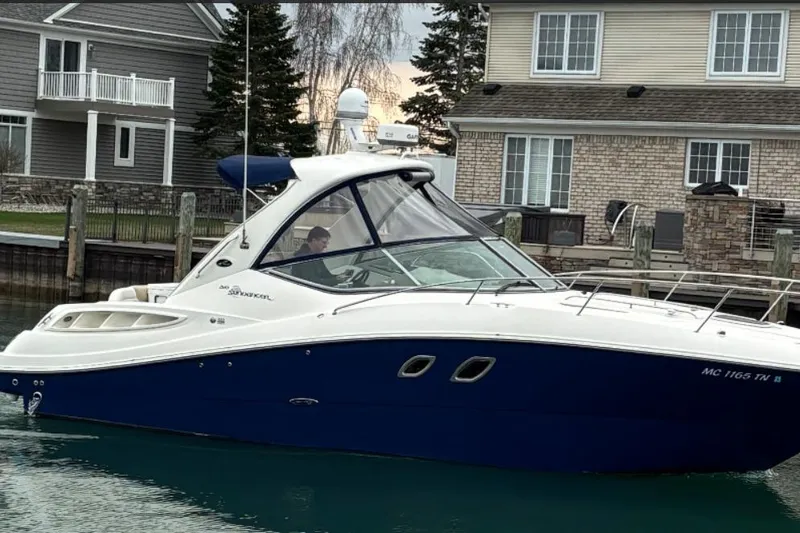 Slide: The Image of 2008 Sea Ray Sundancer 310 boat docked near waterfront homes. - 2