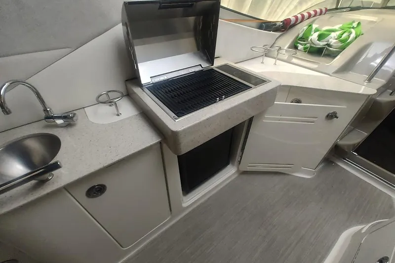 Slide: The Image of 2008 Sea Ray Sundancer 310 boat kitchen with grill, sink, and storage cabinets. - 21
