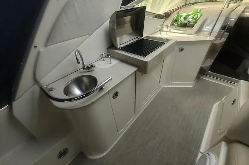 Slide: The Image of 2008 Sea Ray Sundancer 310 interior with sink and grill in the galley area. - 22