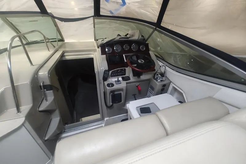 Slide: The Image of 2008 Sea Ray Sundancer 310 cockpit with steering wheel and control panel. - 24