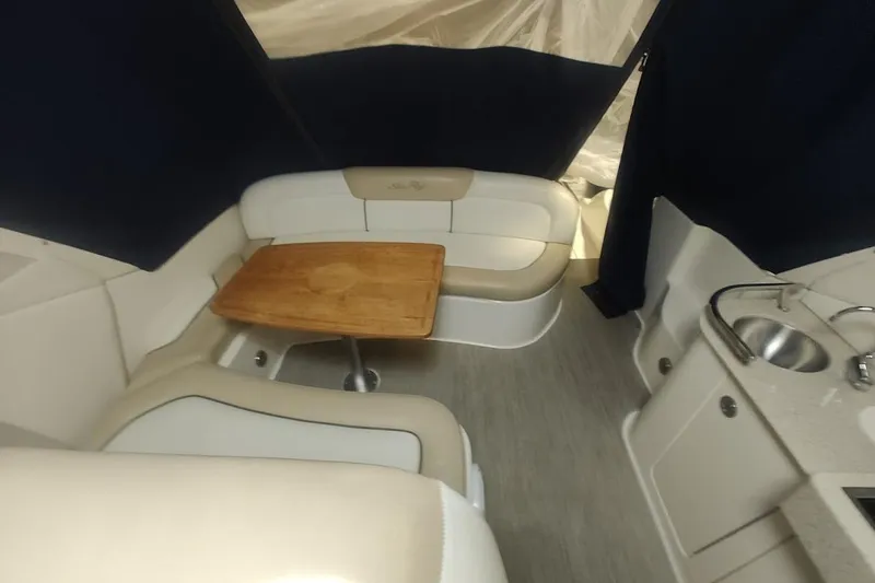 Slide: The Image of 2008 Sea Ray Sundancer 310 interior with seating, table, and kitchenette. - 25