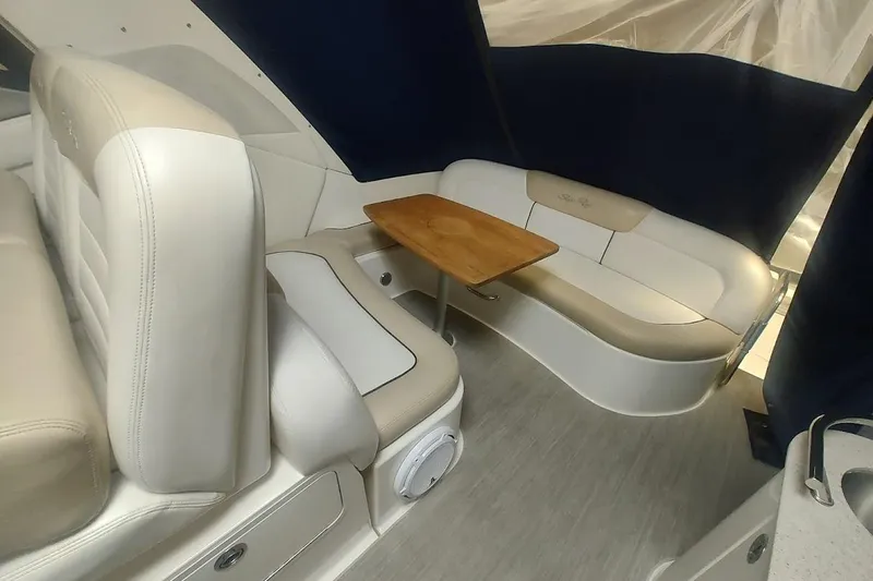 Slide: The Image of 2008 Sea Ray Sundancer 310 interior with beige seating and wooden table. - 26