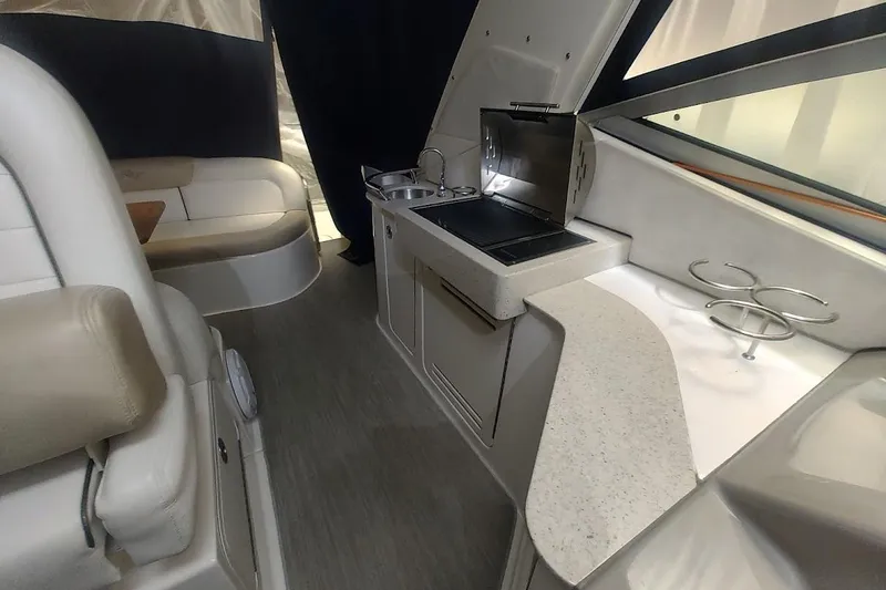 Slide: The Image of 2008 Sea Ray Sundancer 310 interior with kitchenette and seating area. - 6