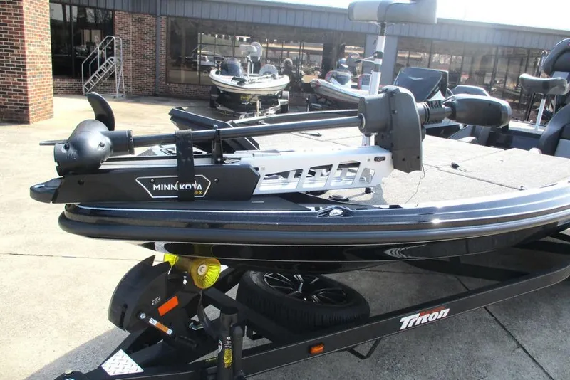 Slide: The Image of Triton 20XP 2025 boat with Minn Kota trolling motor on trailer. - 11