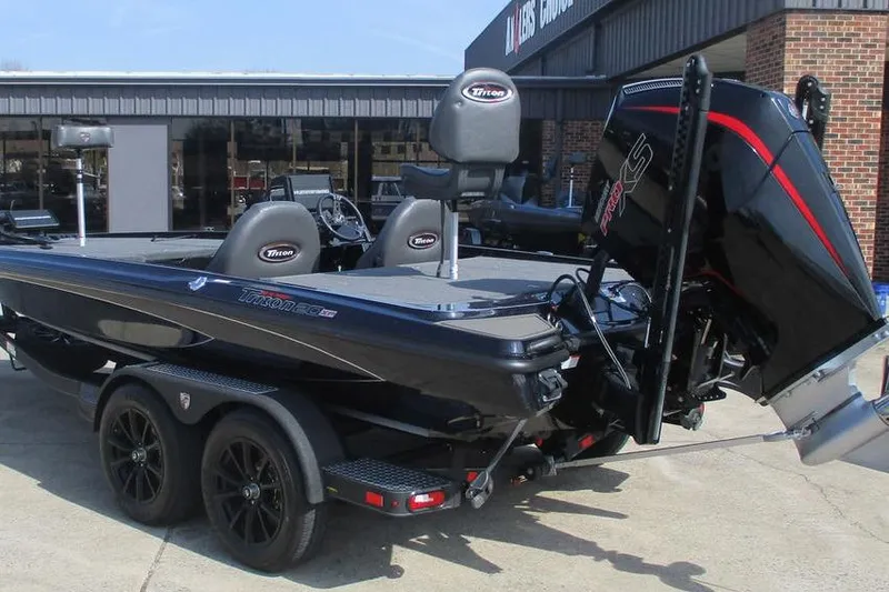 Slide: The Image of 2025 Triton 20XP boat with trailer, featuring sleek design and powerful engine. - 2